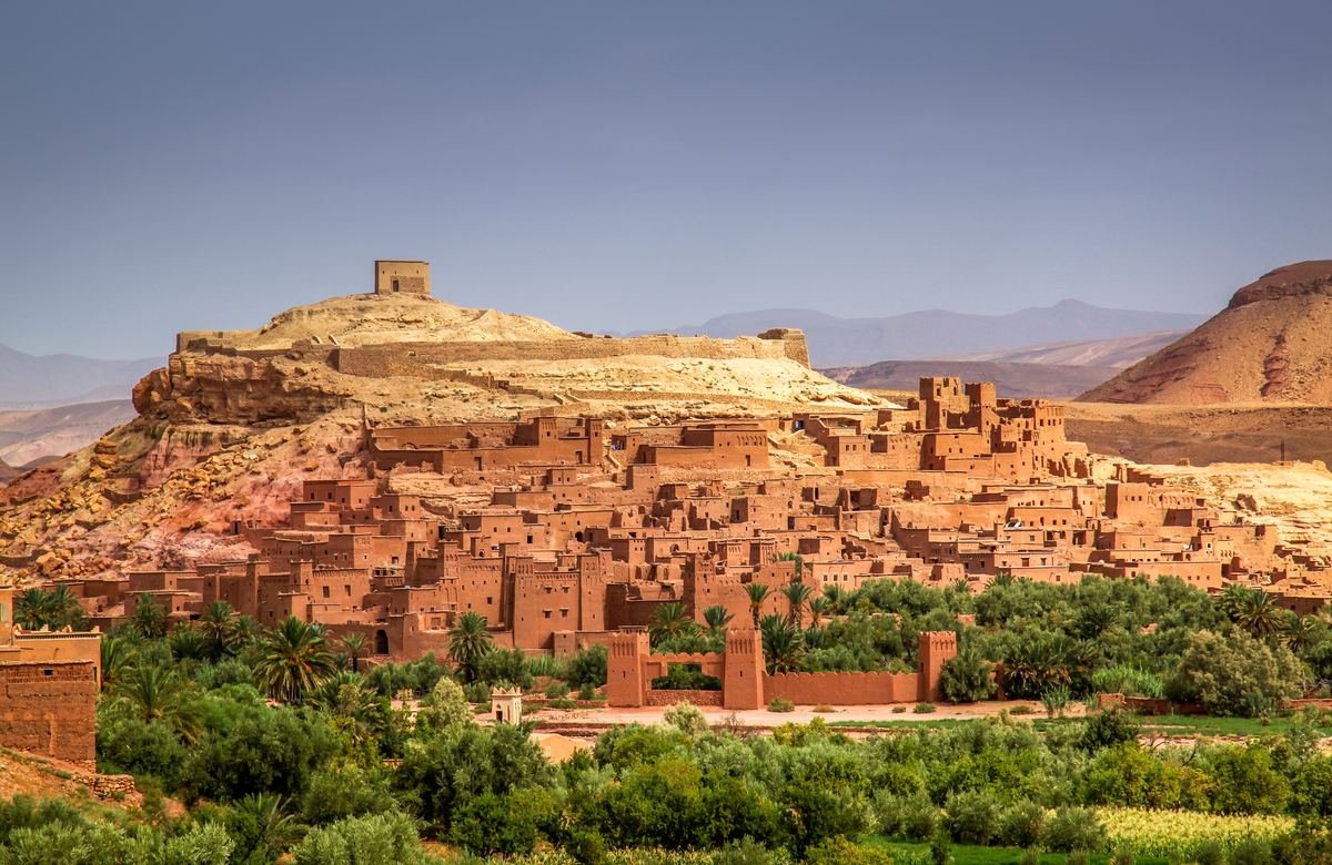 Panorama of the earthen ksar of Ait Benhaddou above green palms